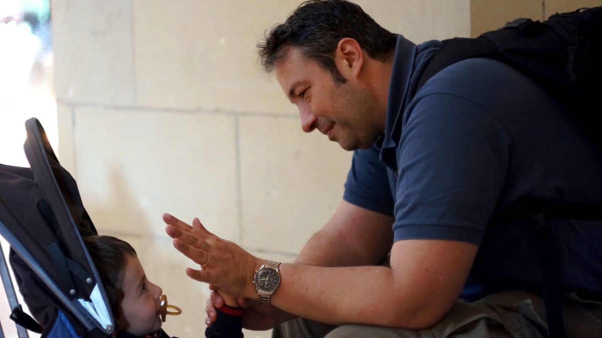 A father and his young child looking at each other with love and admiration. This photograph was taken in the Sagrada Familia cathedral in Barcelona.