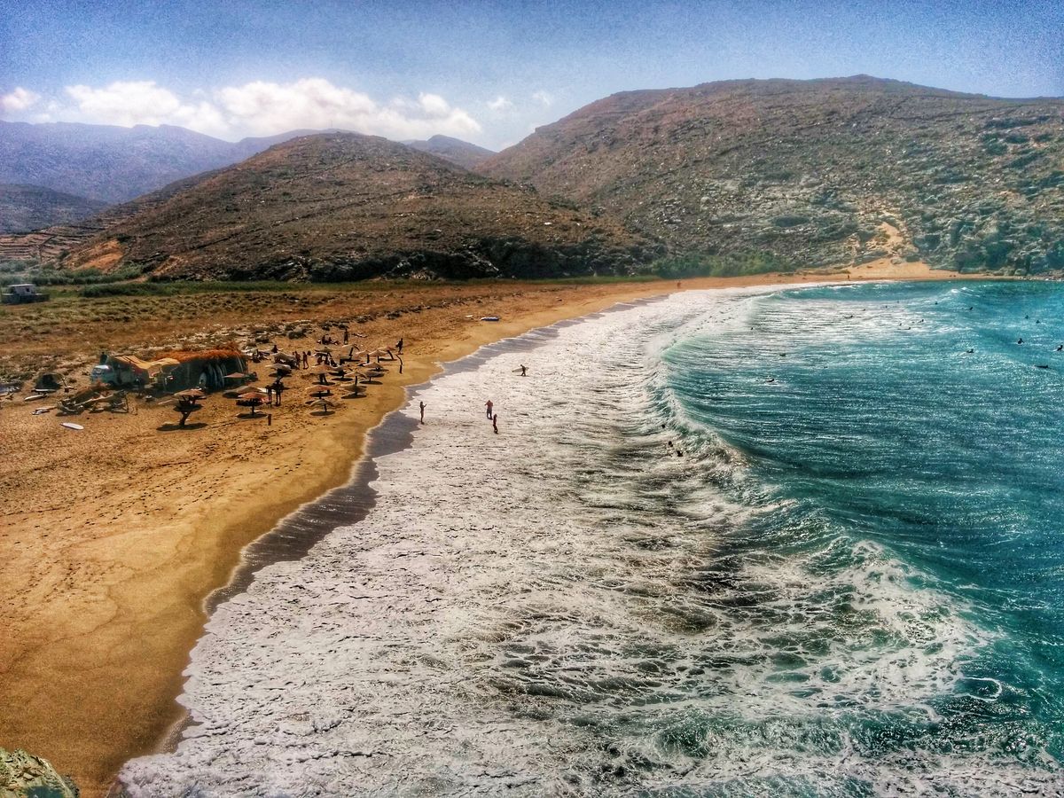 Summer day with north winds means perfect waves for surf in kolibithra beach in Tinos island - Greece